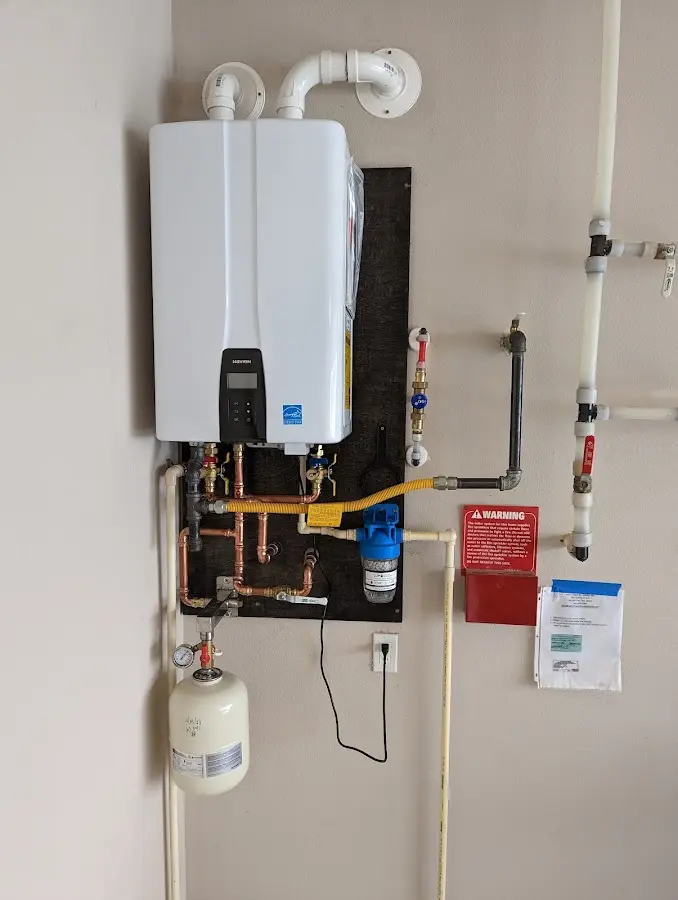 Professional plumber installing copper piping in a Dentsville home